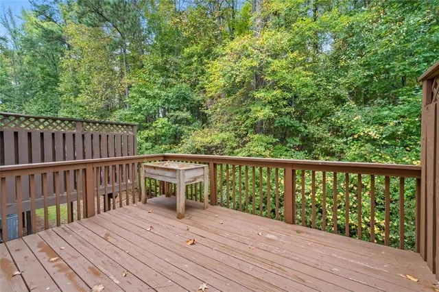 a view of balcony with wooden floor and fence