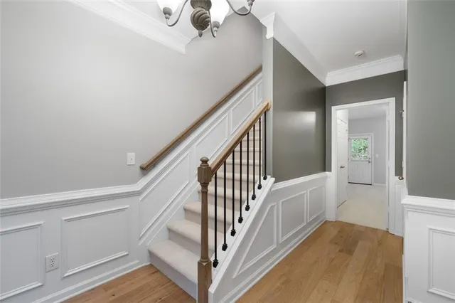 a view of staircase with railing and white walls