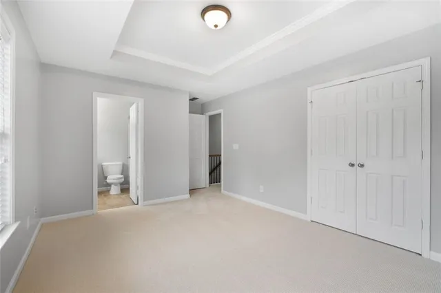 a bathroom with a toilet a sink and a window