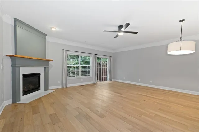 a view of empty room with a fireplace and fan