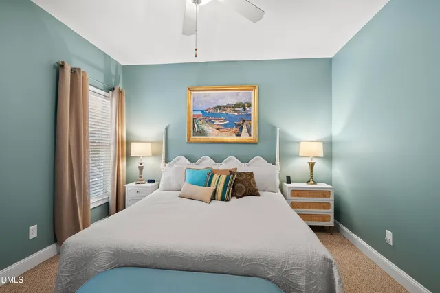 a bedroom with bed and a chandelier