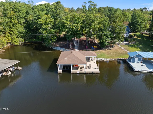 an aerial view of a house with swimming pool patio and lake view