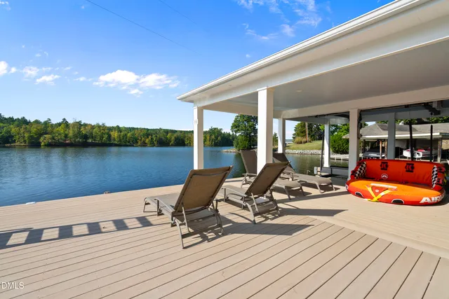 an aerial view of a house with swimming pool outdoor seating and yard