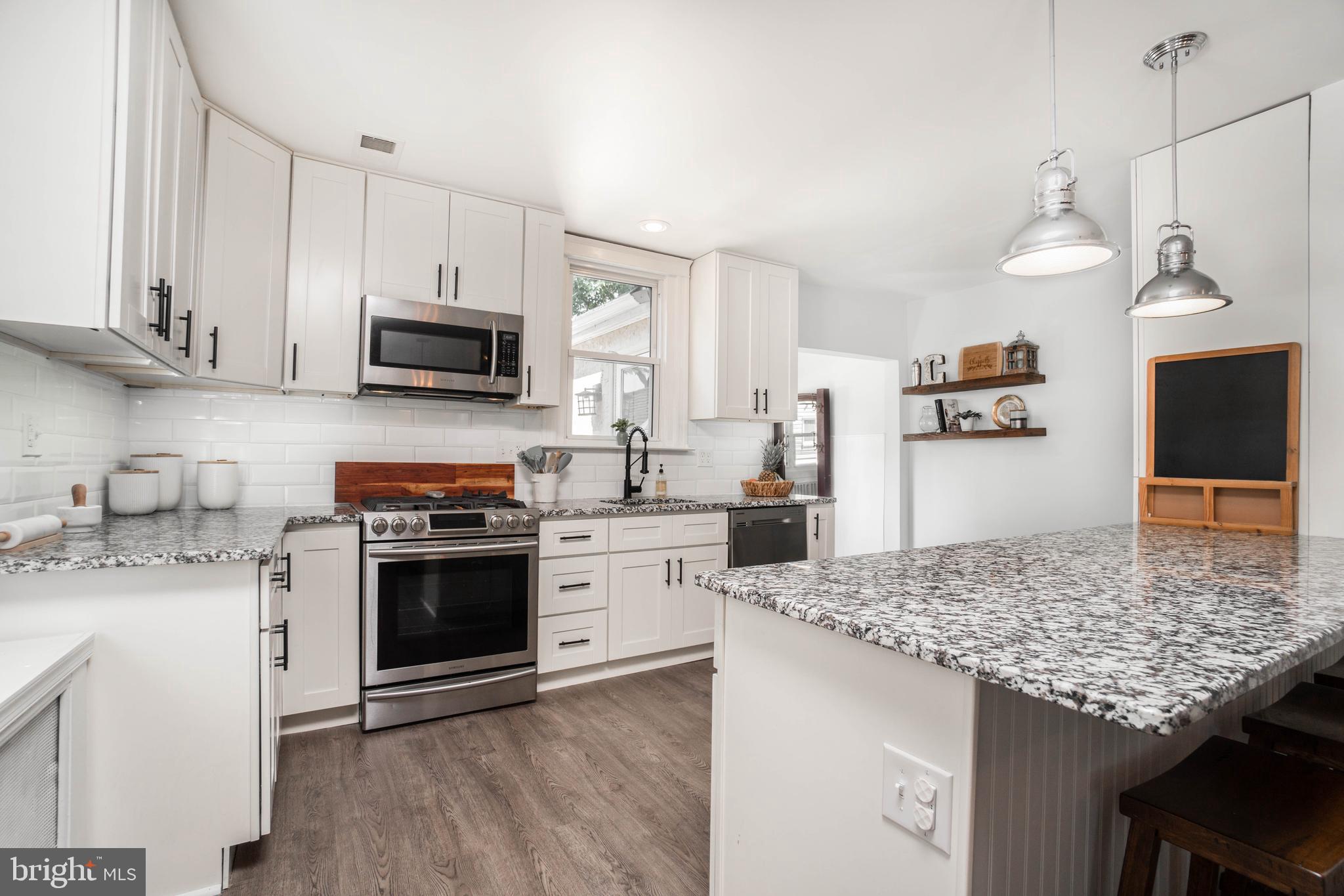 2912 Mapleshade Road Ardmore, PA 19003 - Photo 19 of 46 a kitchen with granite countertop a sink cabinets stainless steel appliances and a counter space