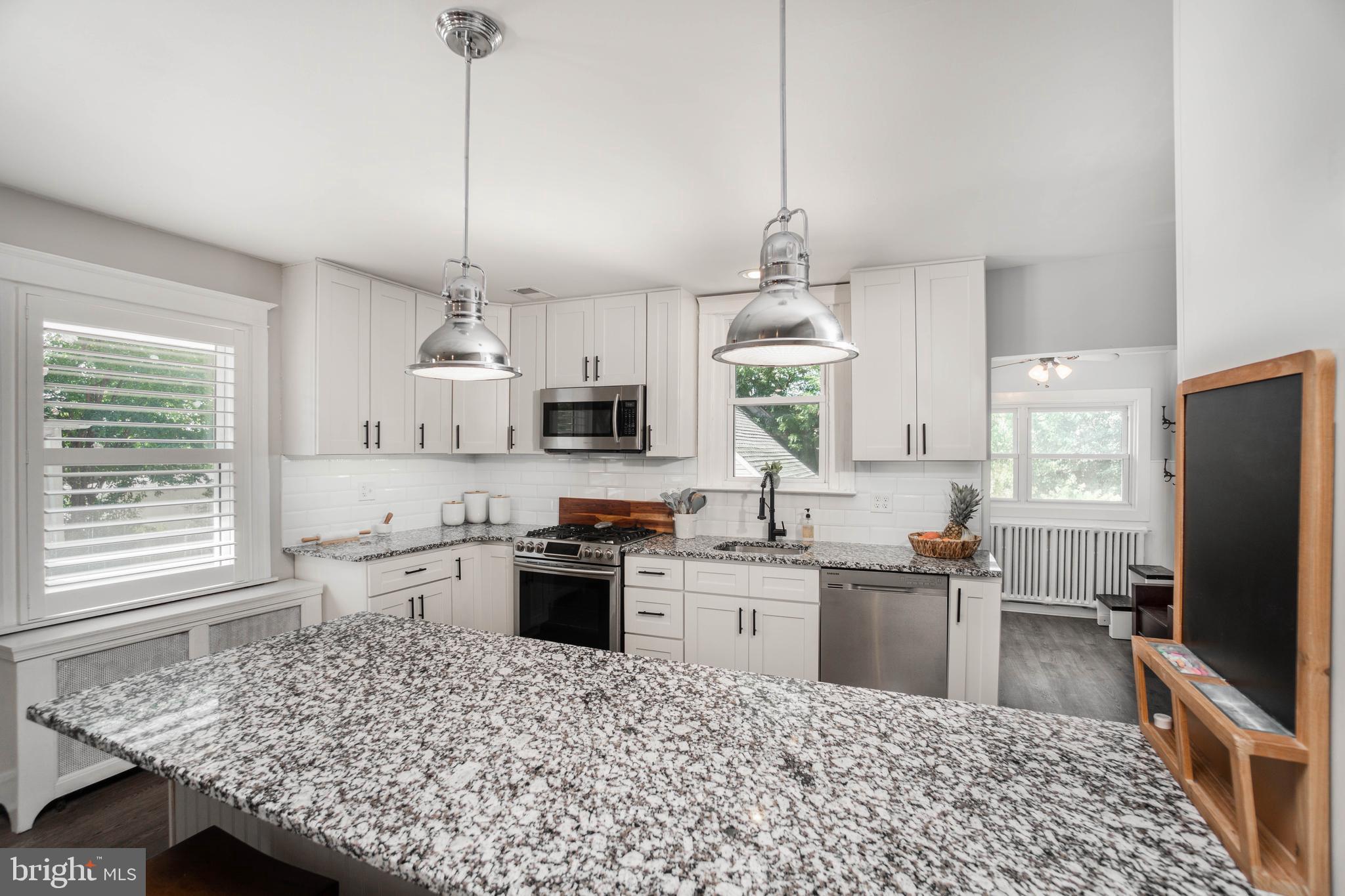 2912 Mapleshade Road Ardmore, PA 19003 - Photo 21 of 46 a kitchen with kitchen island granite countertop a sink appliances cabinets and a counter top space