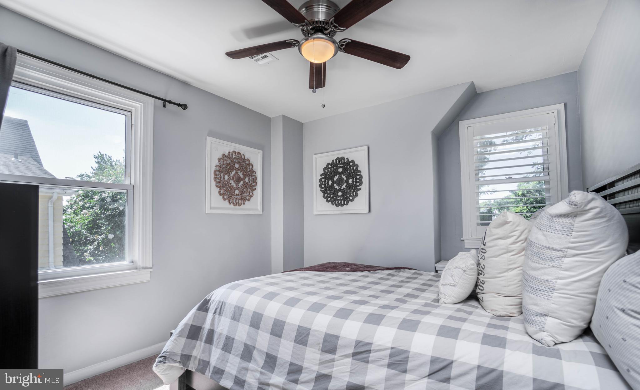 2912 Mapleshade Road Ardmore, PA 19003 - Photo 33 of 46 a bedroom with a bed and a chandelier