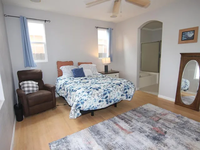 a bedroom with a bed couch and a window