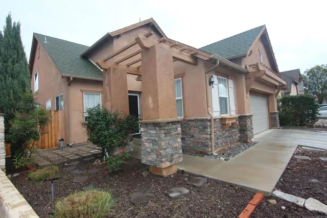 a front view of a house with garden