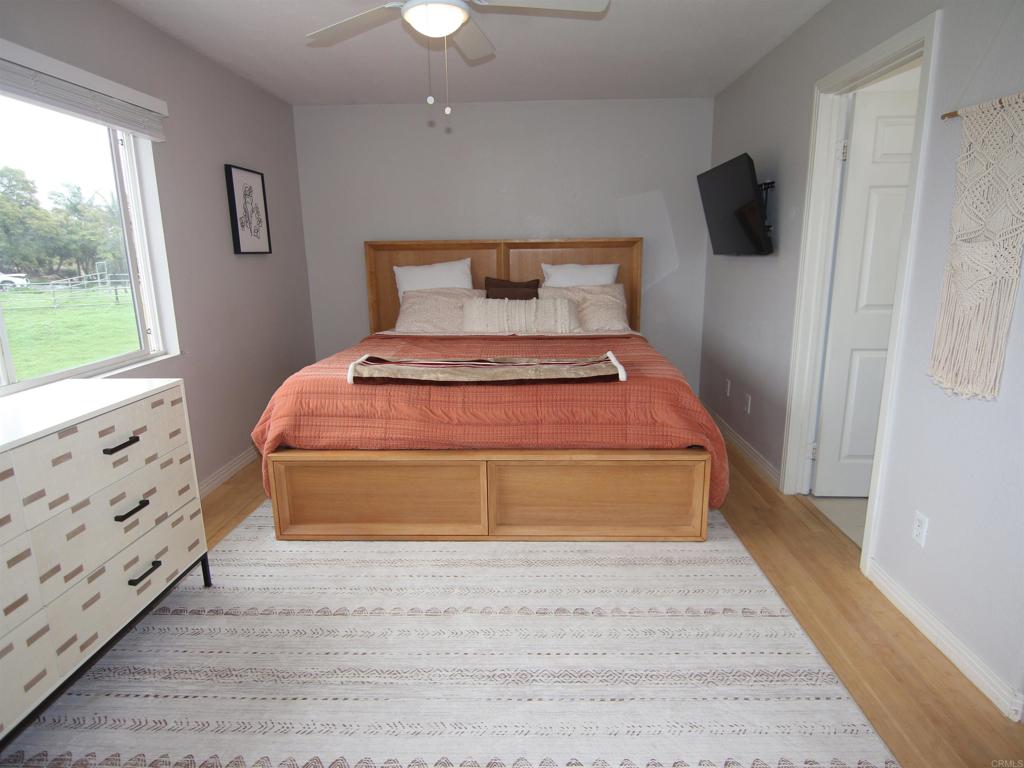 445 Poets Square Fallbrook, CA 92028 - Photo 24 of 37 a bedroom with a bed and a window