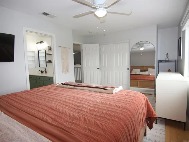 a bedroom with a bed and a television