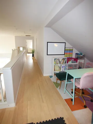 a bedroom with furniture and a wooden floor