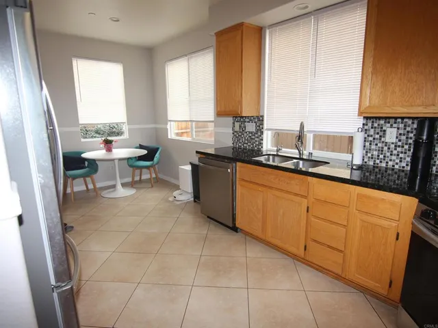 a kitchen with a sink a window and cabinets