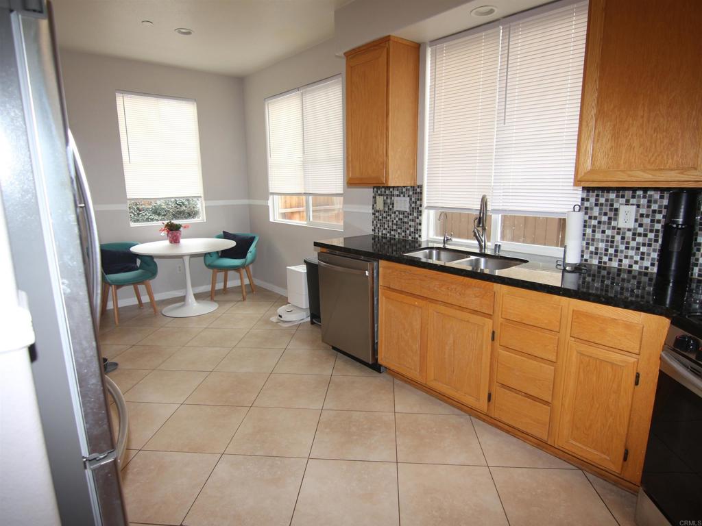 445 Poets Square Fallbrook, CA 92028 - Photo 7 of 37 a kitchen with a sink a window and cabinets