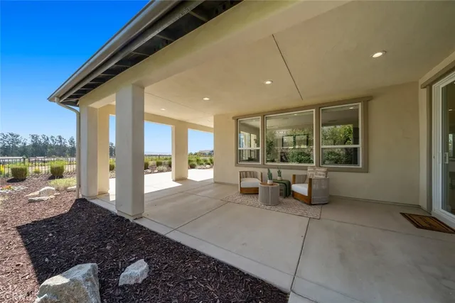 a spacious bedroom with a large window and a table