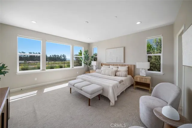 a spacious bedroom with a bed and a large window