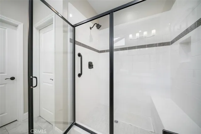 a bathroom with a glass shower door