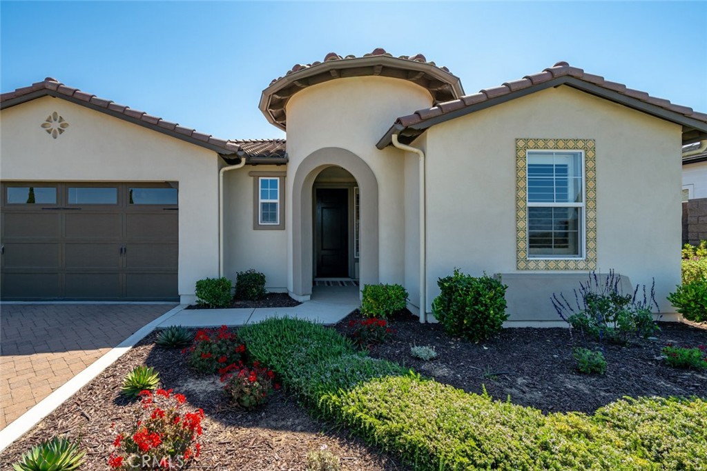 1455 Via Vista Nipomo, CA 93444 - Photo 3 of 34 a front view of a house with a garden