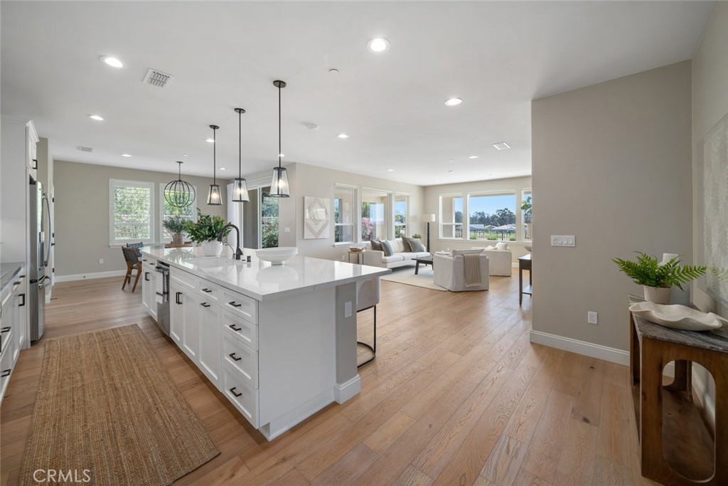 1455 Via Vista Nipomo, CA 93444 - Photo 4 of 34 a large white kitchen with a large window a sink and stainless steel appliances