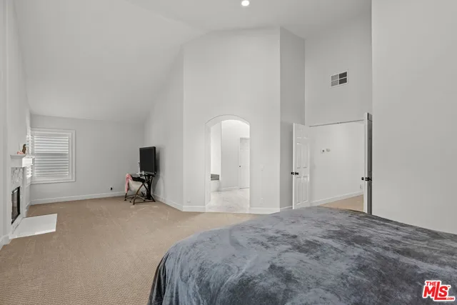 a spacious bedroom with a bed and a cabinets