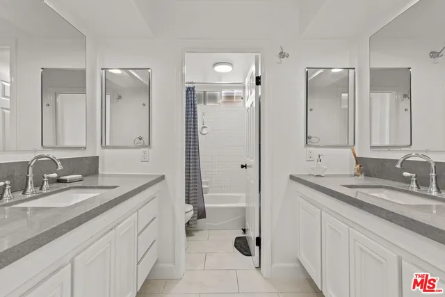 a bathroom with a granite countertop sink mirror and double