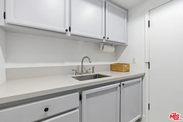 a kitchen with a sink and cabinets