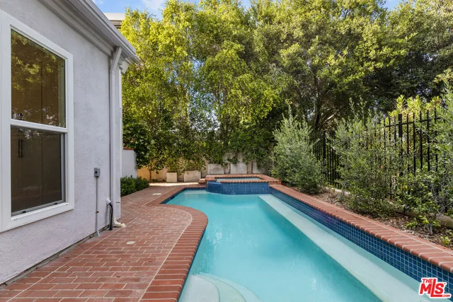 a view of a house with pool and chairs