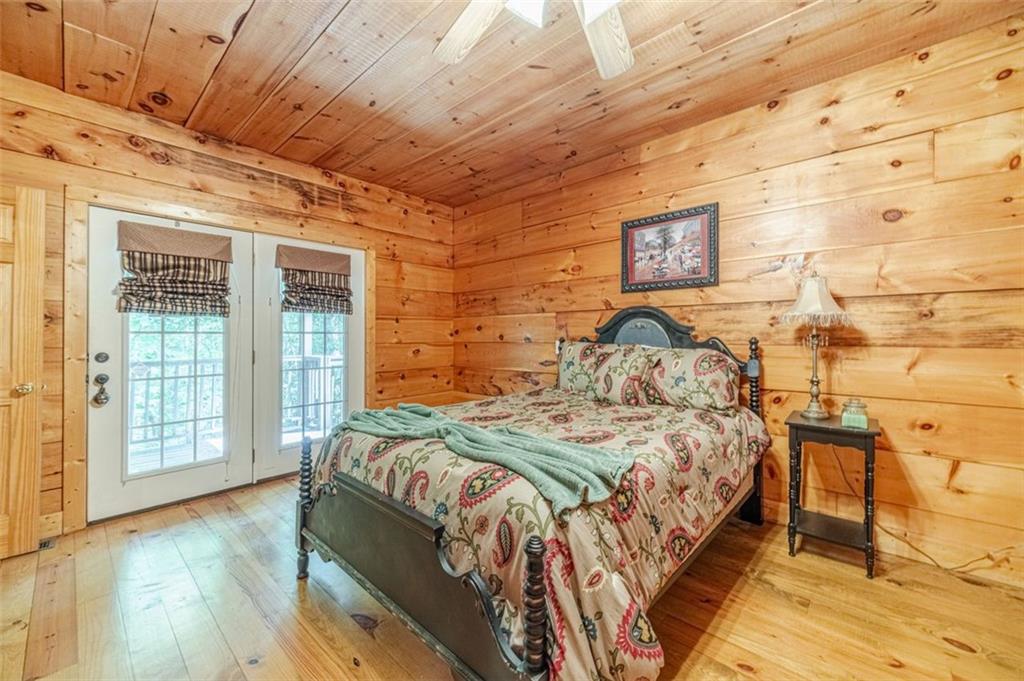 2970 Sky Lake Road Sautee Nacoochee, GA 30571 - Photo 17 of 53 a bed sitting in a bedroom next to a window