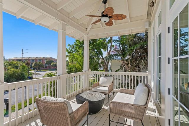 a view of a chair and table in the balcony