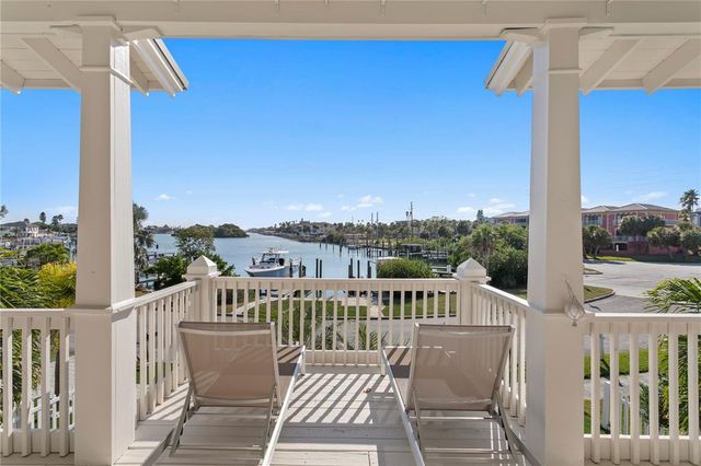 a view of a city from a roof deck with furniture