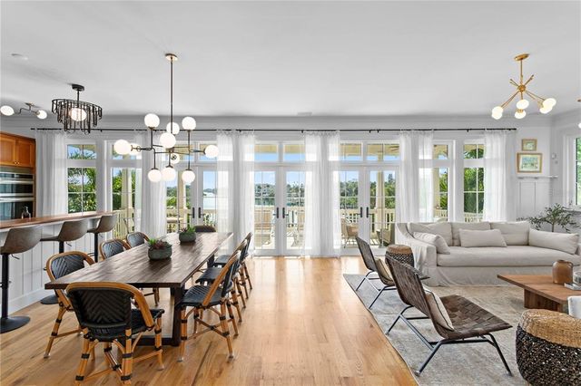 a view of a dining room with furniture wooden floor and chandelier