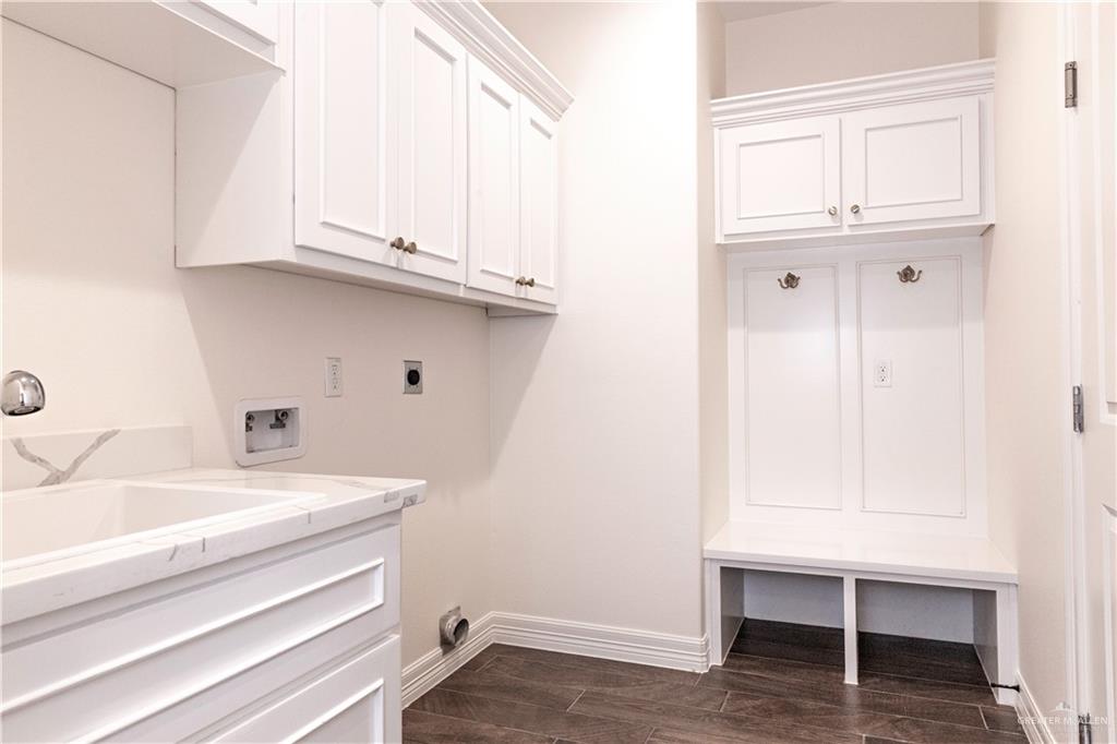 2701 Thompson Street Mission, TX 78573 - Photo 17 of 23 Laundry room/mud room with entry to the garage. Features electric dryer hookup, washer hookup, and a deep sink