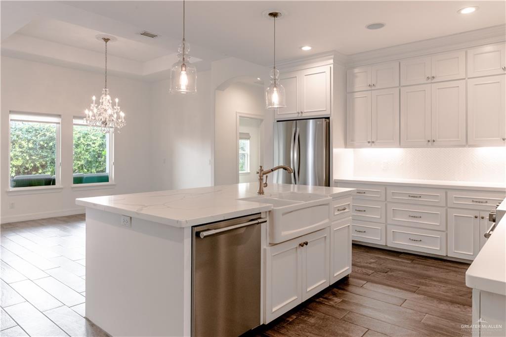2701 Thompson Street Mission, TX 78573 - Photo 4 of 23 Kitchen featuring stainless steel appliances, white cabinets, dark wood-type flooring, plenty of natural light