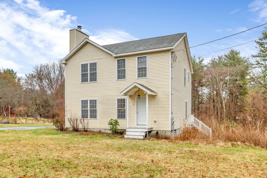 a front view of a house with a yard