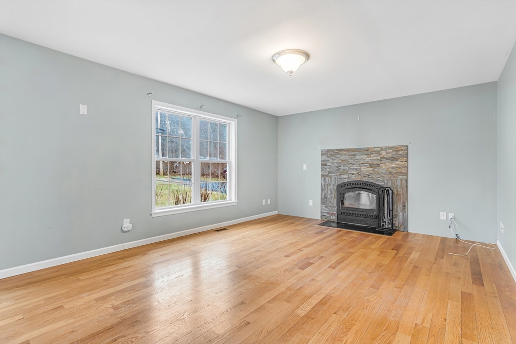 97 Packard Road Stow, MA 01775 - Photo 11 of 31 a view of empty room with wooden floor and fan