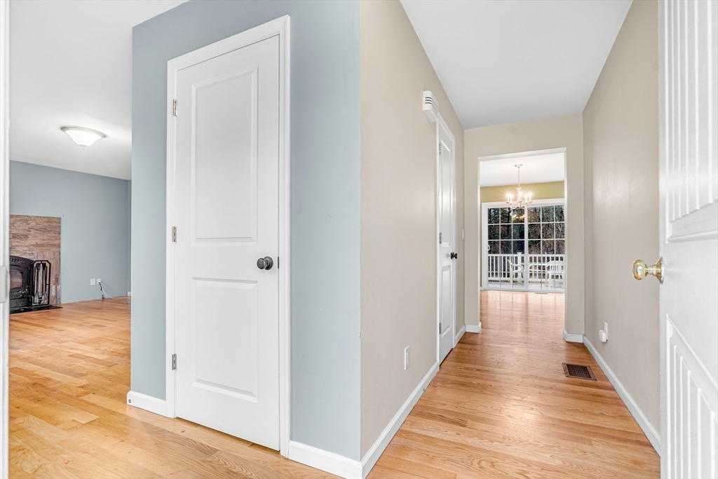 97 Packard Road Stow, MA 01775 - Photo 13 of 31 a view of a hallway with wooden floor and staircase