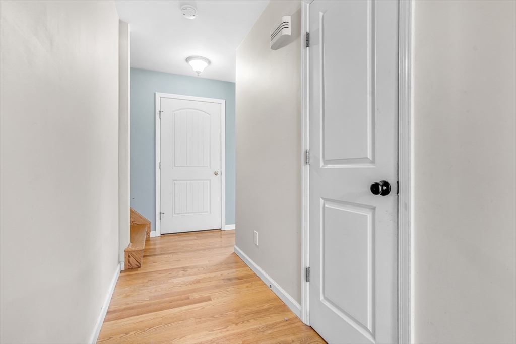 97 Packard Road Stow, MA 01775 - Photo 14 of 31 a view of a hallway with wooden floor