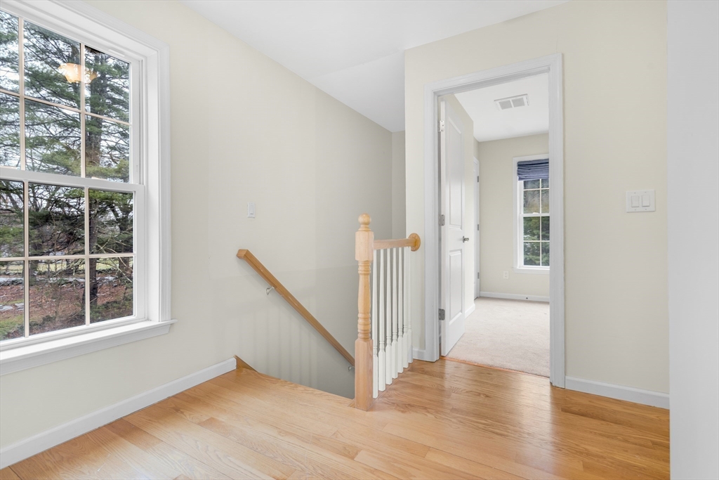 97 Packard Road Stow, MA 01775 - Photo 16 of 31 a view of a hallway with wooden floor and entryway