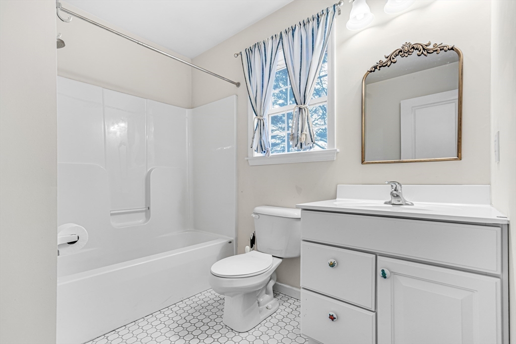 97 Packard Road Stow, MA 01775 - Photo 19 of 31 a bathroom with a toilet sink and mirror