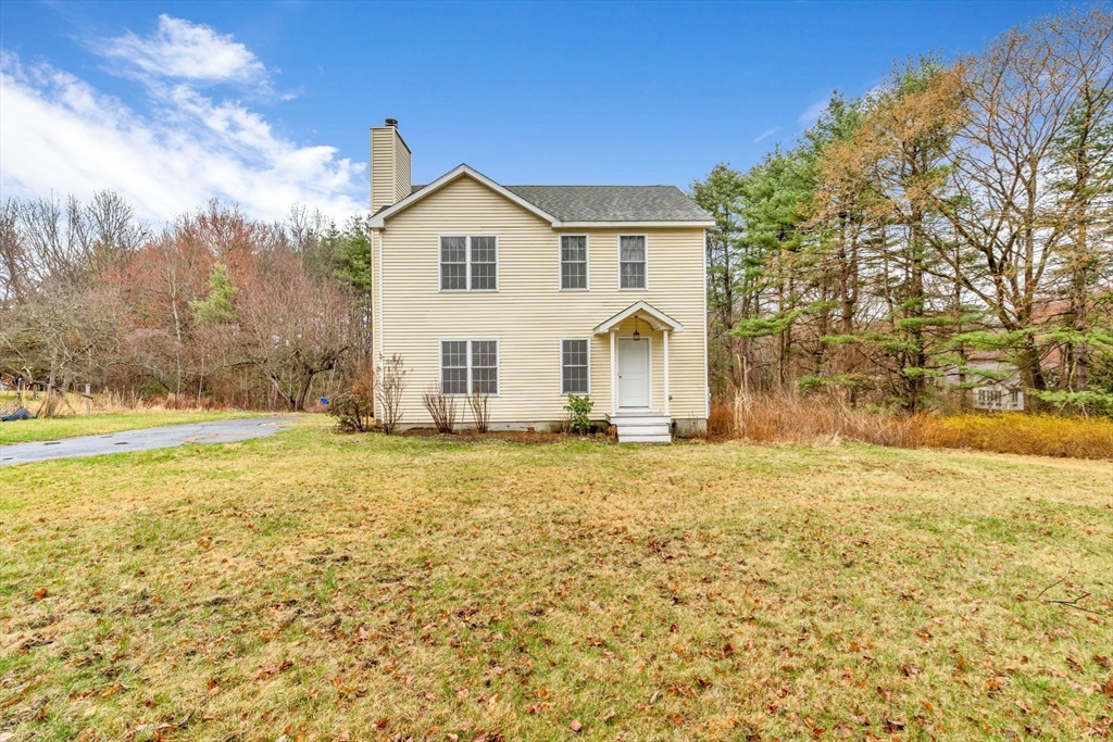 97 Packard Road Stow, MA 01775 - Photo 2 of 31 a view of a white house with a yard and basket ball court