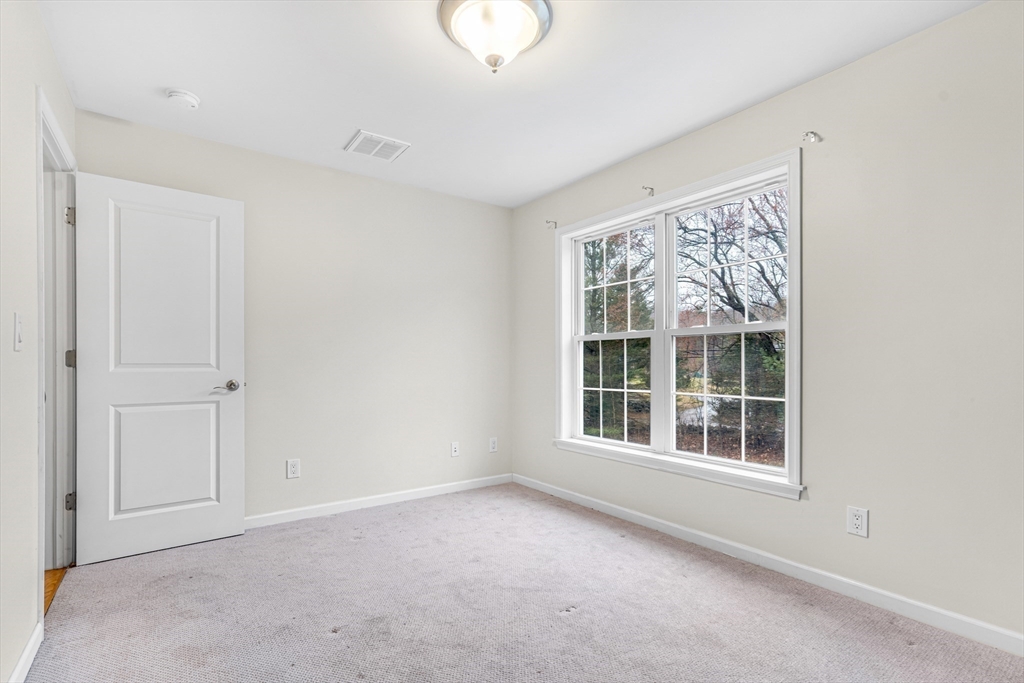 97 Packard Road Stow, MA 01775 - Photo 21 of 31 a view of an empty room with a window