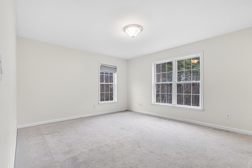 97 Packard Road Stow, MA 01775 - Photo 23 of 31 a view of an empty room with a window