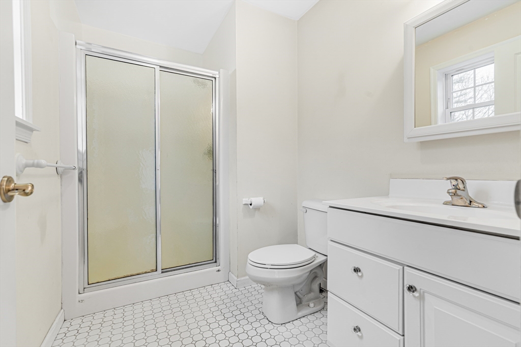 97 Packard Road Stow, MA 01775 - Photo 24 of 31 a bathroom with a granite countertop sink mirror vanity and toilet