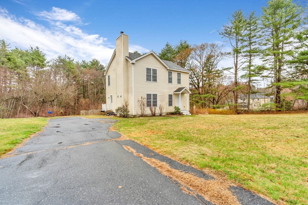 97 Packard Road Stow, MA 01775 - Photo 27 of 31 a view of a white house with a yard