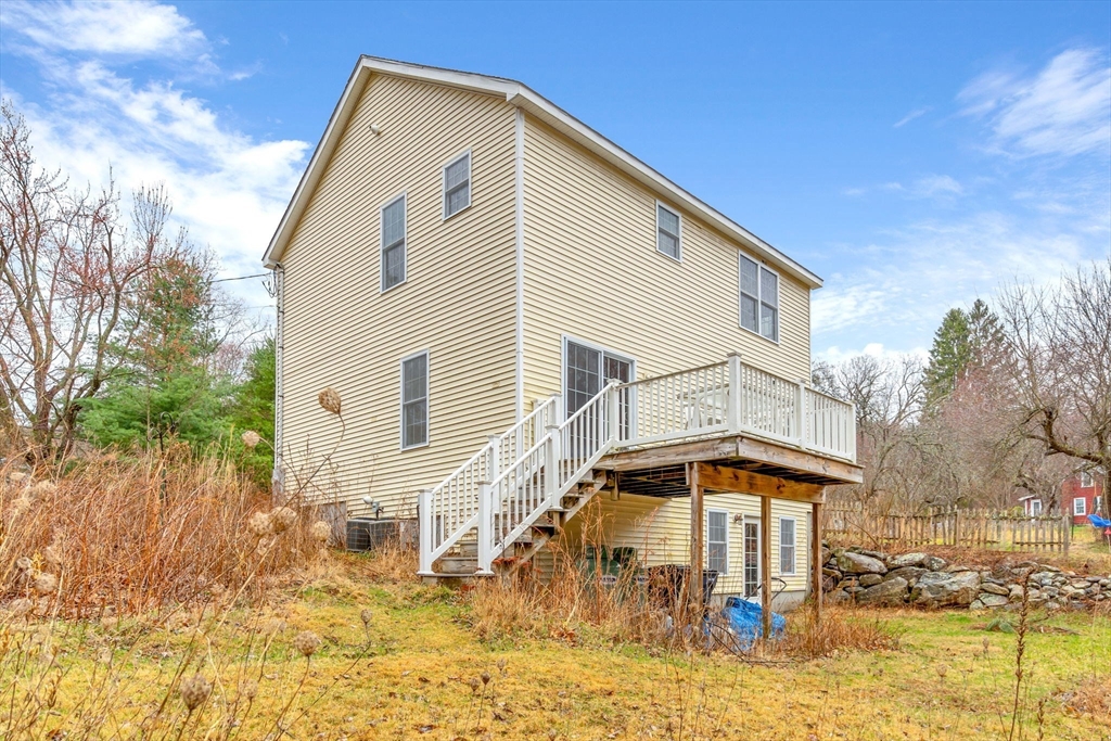 97 Packard Road Stow, MA 01775 - Photo 28 of 31 a front view of a house with a yard