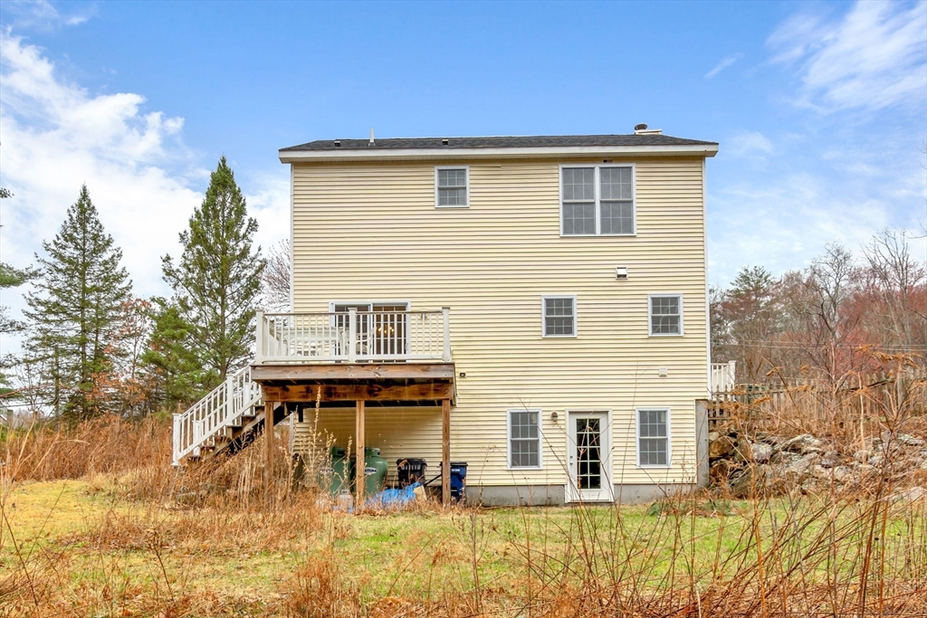 97 Packard Road Stow, MA 01775 - Photo 29 of 31 a front view of a house with a yard