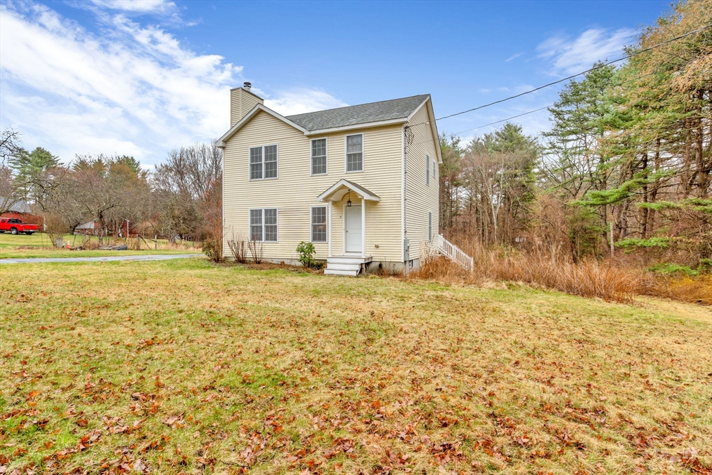 97 Packard Road Stow, MA 01775 - Photo 30 of 31 a front view of a house with a yard