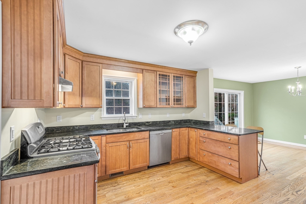 97 Packard Road Stow, MA 01775 - Photo 3 of 31 a kitchen with stainless steel appliances granite countertop a stove a sink and a microwave