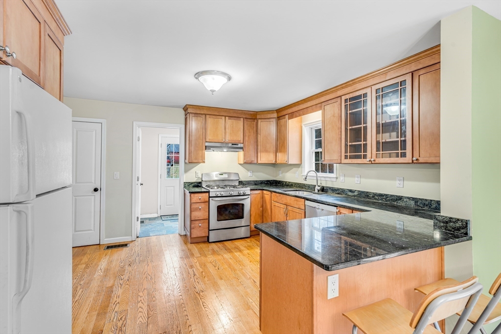 97 Packard Road Stow, MA 01775 - Photo 6 of 31 a kitchen with stainless steel appliances granite countertop a sink stove and refrigerator