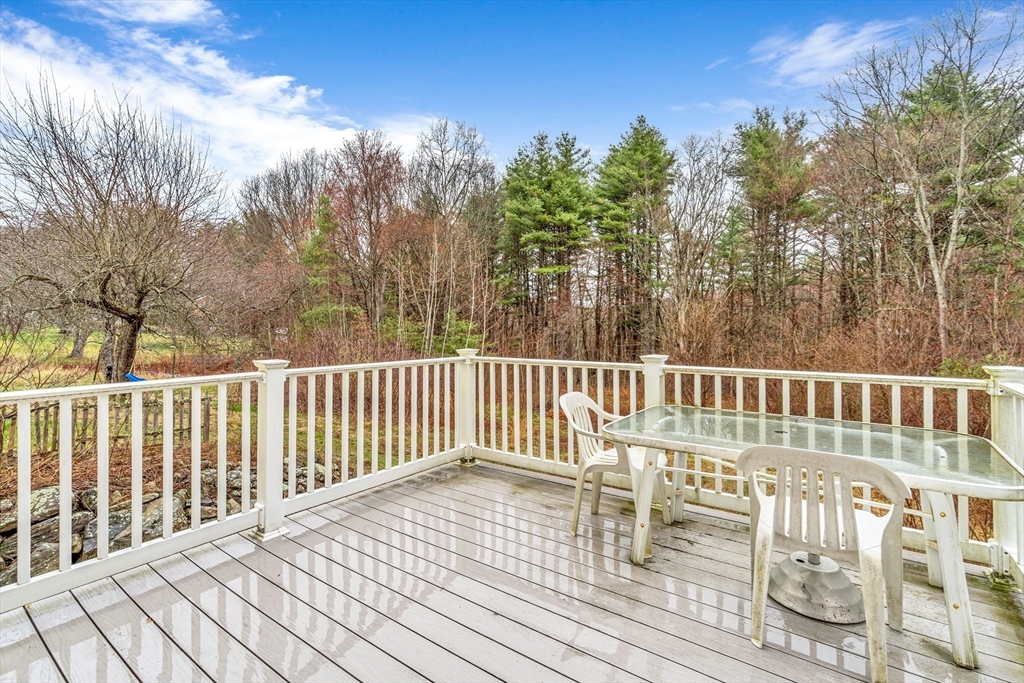 97 Packard Road Stow, MA 01775 - Photo 8 of 31 a balcony with wooden floor and fence