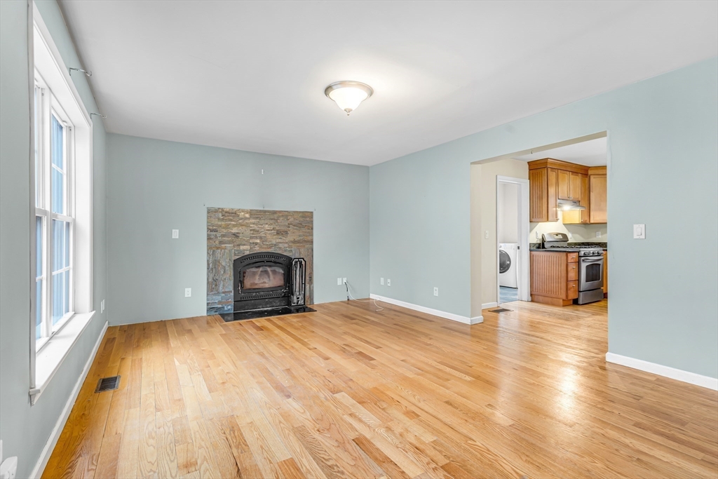 97 Packard Road Stow, MA 01775 - Photo 10 of 31 a view of a room with wooden floor fireplace and windows
